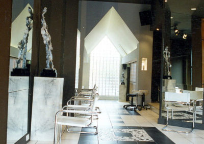 modern salon interior with white chairs and large mirrors