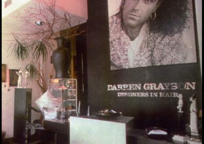 a large darren grayson poster inside a salon