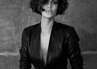 lady with short wavy hair wearing a black jacket