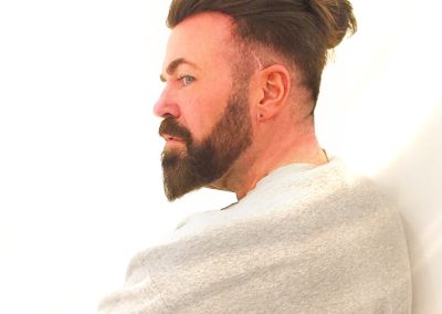 man with tied hair and beard