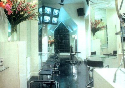 salon with salon chairs large mirrors and black floor