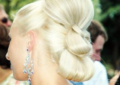 lady with blonde braided hair wearing a beaded earring in an event